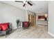 Bright living area featuring wood floors, a ceiling fan, built-in shelves and an open view to the kitchen at 100 4Th S Ave # 220, St Petersburg, FL 33701
