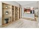 Open-concept living room with hardwood floors, neutral walls, modern lighting, and access to the kitchen at 100 4Th S Ave # 220, St Petersburg, FL 33701