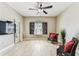Bright living room with wood-look flooring, ceiling fan, and large window creating a comfortable living space at 100 4Th S Ave # 220, St Petersburg, FL 33701
