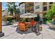 Outdoor patio with umbrellas, tables, chairs, sofas, and a rocking chair in front of condos at 100 4Th S Ave # 220, St Petersburg, FL 33701