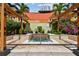 Community pool with a shaded pergola, lush landscaping, and sunny skies at 100 4Th S Ave # 220, St Petersburg, FL 33701