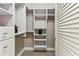 Walk-in closet with white custom shelving and drawers providing ample storage space at 100 4Th S Ave # 220, St Petersburg, FL 33701