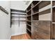 Walk-in closet with dark wood custom shelving and drawers providing ample storage space at 100 4Th S Ave # 220, St Petersburg, FL 33701