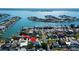 Gorgeous elevated aerial view home nestled waterfront community with stunning water views and lush landscaping at 103 Morgan Dr, Belleair Beach, FL 33786