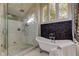 Spa-like bathroom showcasing a freestanding tub, walk-in shower, and mosaic tile accent wall at 103 Morgan Dr, Belleair Beach, FL 33786