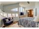 Well-lit bedroom featuring unique windows, hardwood floors, a cozy chair, and a blue accent chair at 103 Morgan Dr, Belleair Beach, FL 33786