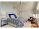 Bright bedroom with blue accents, hardwood floors, and ample closet space for a relaxing retreat at 103 Morgan Dr, Belleair Beach, FL 33786