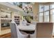 Charming dining room with a tiled fireplace, overhead chandelier, staircase, and a sunlit sitting area at 103 Morgan Dr, Belleair Beach, FL 33786