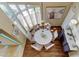 Elegant dining area with wood floors, a hanging chandelier, decorative art, and ample seating at 103 Morgan Dr, Belleair Beach, FL 33786