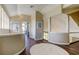 Neutral-toned hallway featuring wood floors, a round rug, and a view of a fireplace and living room at 103 Morgan Dr, Belleair Beach, FL 33786