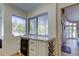 Kitchenette area with a wine refrigerator, built-in wine rack, and natural light at 103 Morgan Dr, Belleair Beach, FL 33786