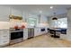 Modern kitchen with stainless steel appliances, granite countertops, and bright lighting at 103 Morgan Dr, Belleair Beach, FL 33786