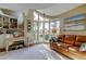 Inviting sitting room with a leather couch, bright windows, elegant decor, and comfortable furnishings at 103 Morgan Dr, Belleair Beach, FL 33786