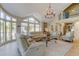 Inviting living room featuring large windows, comfortable seating, and an open floor plan at 103 Morgan Dr, Belleair Beach, FL 33786