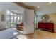 Sunlit living room showcasing a leather couch, hardwood floors, an ornate mirror, and a sun-drenched open space at 103 Morgan Dr, Belleair Beach, FL 33786