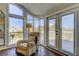 Comfortable sitting area with beach views through large windows and access to an outdoor deck at 103 Morgan Dr, Belleair Beach, FL 33786