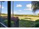 Backyard view showing lush greenery and waterfront view providing a serene backdrop at 1030 Tidewater Shores Loop # 104, Bradenton, FL 34208