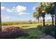 Peaceful backyard with manicured lawn and waterfront view offering a tranquil oasis at 1030 Tidewater Shores Loop # 104, Bradenton, FL 34208
