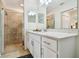 Bathroom featuring a white vanity, ample counter space, and a glass-enclosed tiled shower at 1030 Tidewater Shores Loop # 104, Bradenton, FL 34208