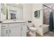 Well-lit bathroom with a sleek vanity, quartz countertop, toilet, and shower-tub combo with tiled surround at 1030 Tidewater Shores Loop # 104, Bradenton, FL 34208