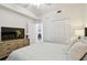 Bright bedroom featuring a neutral color palette, light wood dresser, and access to an ensuite bathroom at 1030 Tidewater Shores Loop # 104, Bradenton, FL 34208