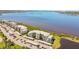 Aerial view of condominiums on waterfront featuring lush landscaping and plenty of parking at 1030 Tidewater Shores Loop # 104, Bradenton, FL 34208
