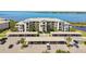 Waterfront condominium featuring covered parking, lush landscaping, and balconies with beautiful views at 1030 Tidewater Shores Loop # 104, Bradenton, FL 34208