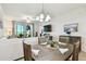 Bright dining area with seating for four and stylish decor, adjacent to a comfortable living space at 1030 Tidewater Shores Loop # 104, Bradenton, FL 34208