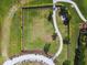 Aerial view of fenced dog park with gravel walking path and benches, next to walking trail at 1030 Tidewater Shores Loop # 104, Bradenton, FL 34208