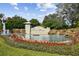 Picturesque community entrance with water features, lush landscaping, and a decorative sign, creating a welcoming ambiance at 1030 Tidewater Shores Loop # 104, Bradenton, FL 34208