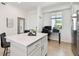 Modern kitchen island with seating and a workspace near the window at 1030 Tidewater Shores Loop # 104, Bradenton, FL 34208