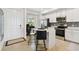 Bright kitchen with an island, stainless steel appliances, and white cabinets at 1030 Tidewater Shores Loop # 104, Bradenton, FL 34208