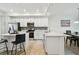 Stylish kitchen featuring an island, stainless steel appliances, and an adjacent dining area at 1030 Tidewater Shores Loop # 104, Bradenton, FL 34208