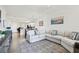 Open concept living area with a comfortable sofa and seamless flow into the kitchen and dining spaces at 1030 Tidewater Shores Loop # 104, Bradenton, FL 34208