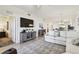 Bright and airy living area with modern media center, open to the kitchen, and updated flooring at 1030 Tidewater Shores Loop # 104, Bradenton, FL 34208