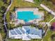 Aerial view of a large swimming pool featuring swimming lanes, tanning ledge, and plenty of lounge chairs at 1030 Tidewater Shores Loop # 104, Bradenton, FL 34208
