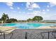 Community swimming pool features shallow area and swimming area along with plenty of lounge chairs at 1030 Tidewater Shores Loop # 104, Bradenton, FL 34208