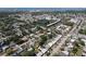 Aerial view showcasing the neighborhood with nearby bodies of water and commercial development at 10754 63Rd Ave, Seminole, FL 33772