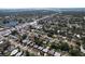 Aerial view showcasing the neighborhood with nearby bodies of water and commercial development at 10754 63Rd Ave, Seminole, FL 33772