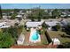 Aerial view of a home with a private backyard featuring a pool and two storage sheds, perfect for outdoor living at 10754 63Rd Ave, Seminole, FL 33772