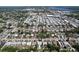 An aerial view showcasing the neighborhood with tree-lined streets and nearby commercial areas at 10754 63Rd Ave, Seminole, FL 33772