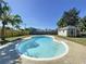 Backyard with lush greenery features a private swimming pool and a shed for storage or hobbies at 10754 63Rd Ave, Seminole, FL 33772