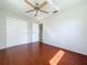 The bedroom features hardwood floors, a ceiling fan, and a closet at 10754 63Rd Ave, Seminole, FL 33772