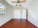 Bedroom featuring hardwood floors, ceiling fan, closet and ample sunlight at 10754 63Rd Ave, Seminole, FL 33772
