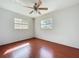 The bedroom includes hardwood floors and two windows for natural light at 10754 63Rd Ave, Seminole, FL 33772