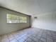 The bonus room has tile flooring, a window for natural light, and an air conditioning unit at 10754 63Rd Ave, Seminole, FL 33772