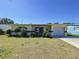 This home features a neat front yard, a small patio, and an attached single-car garage at 10754 63Rd Ave, Seminole, FL 33772