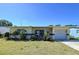 Charming single-story home featuring a well-maintained front lawn, garage, and covered patio at 10754 63Rd Ave, Seminole, FL 33772