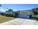 A lovely single-story house showcasing a well-kept lawn, an inviting front porch, and a convenient attached garage at 10754 63Rd Ave, Seminole, FL 33772