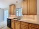 This kitchen features dark appliances, light-colored wood cabinets, and a granite countertop at 10754 63Rd Ave, Seminole, FL 33772
